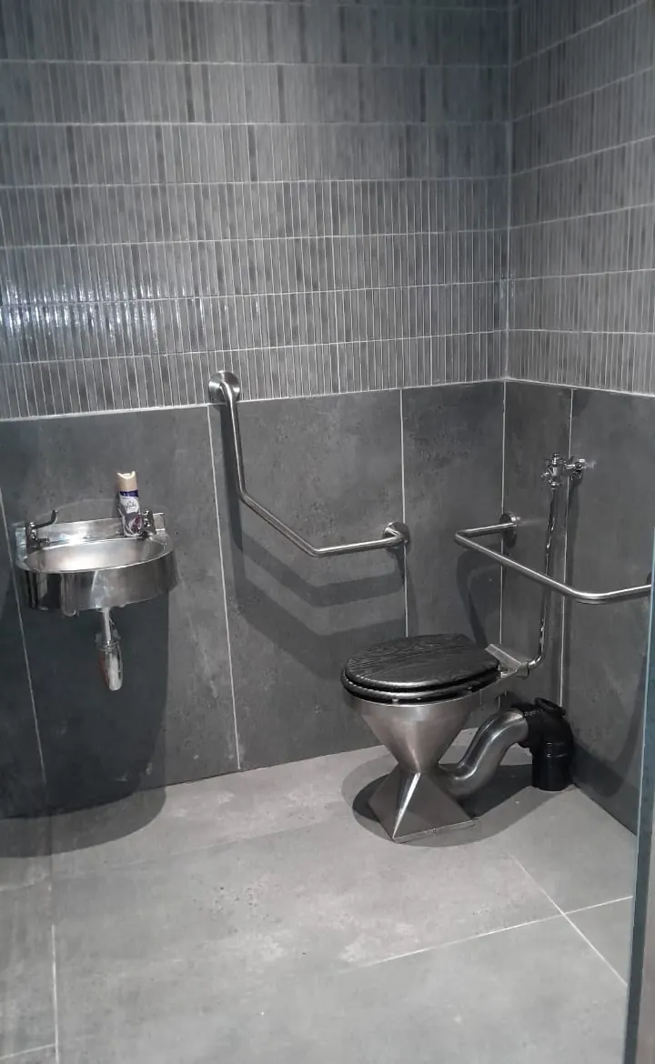 An accessible bathroom with grab rails