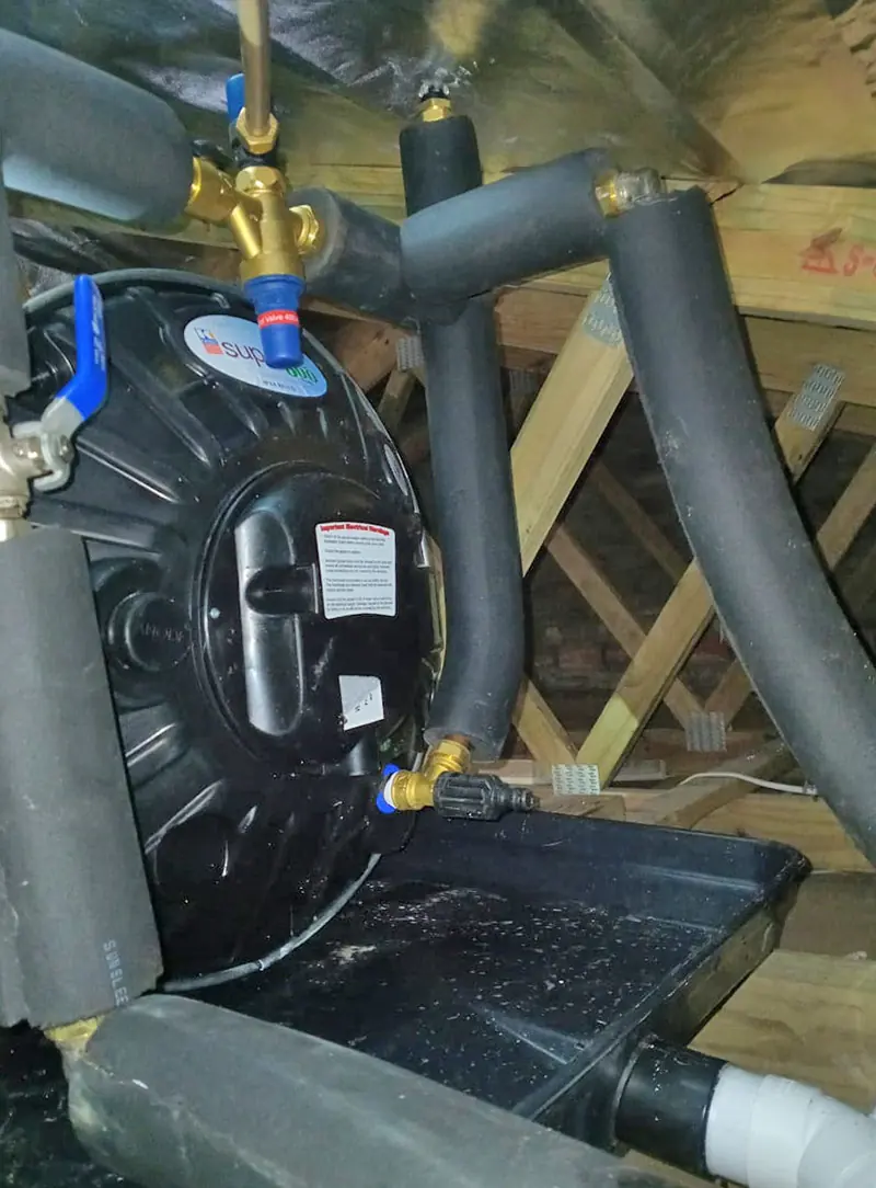 A new geyser in the roof with a drip tray and insulated pipes