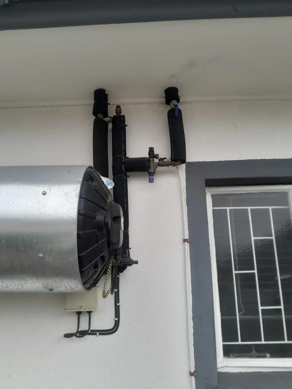A geyser mounted on an outside wall