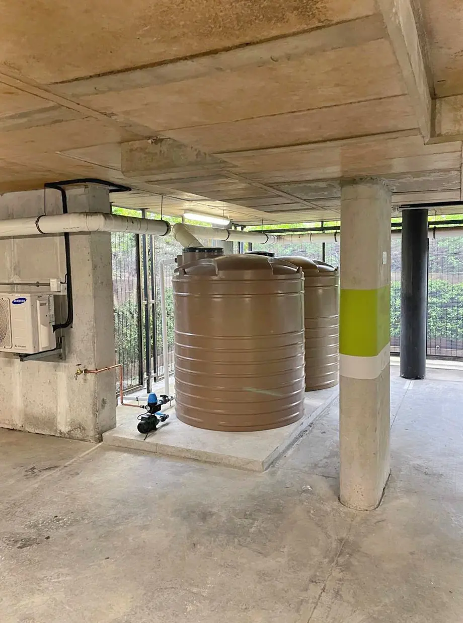 Water storage tanks plumbed in under a building
