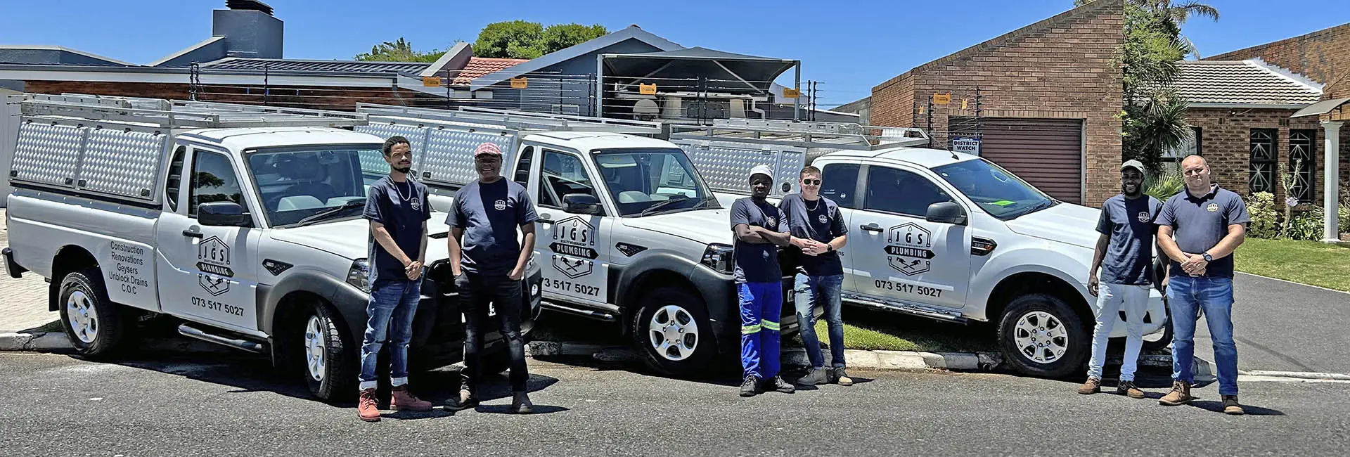 The JGS Plumbing team with their branded bakkies