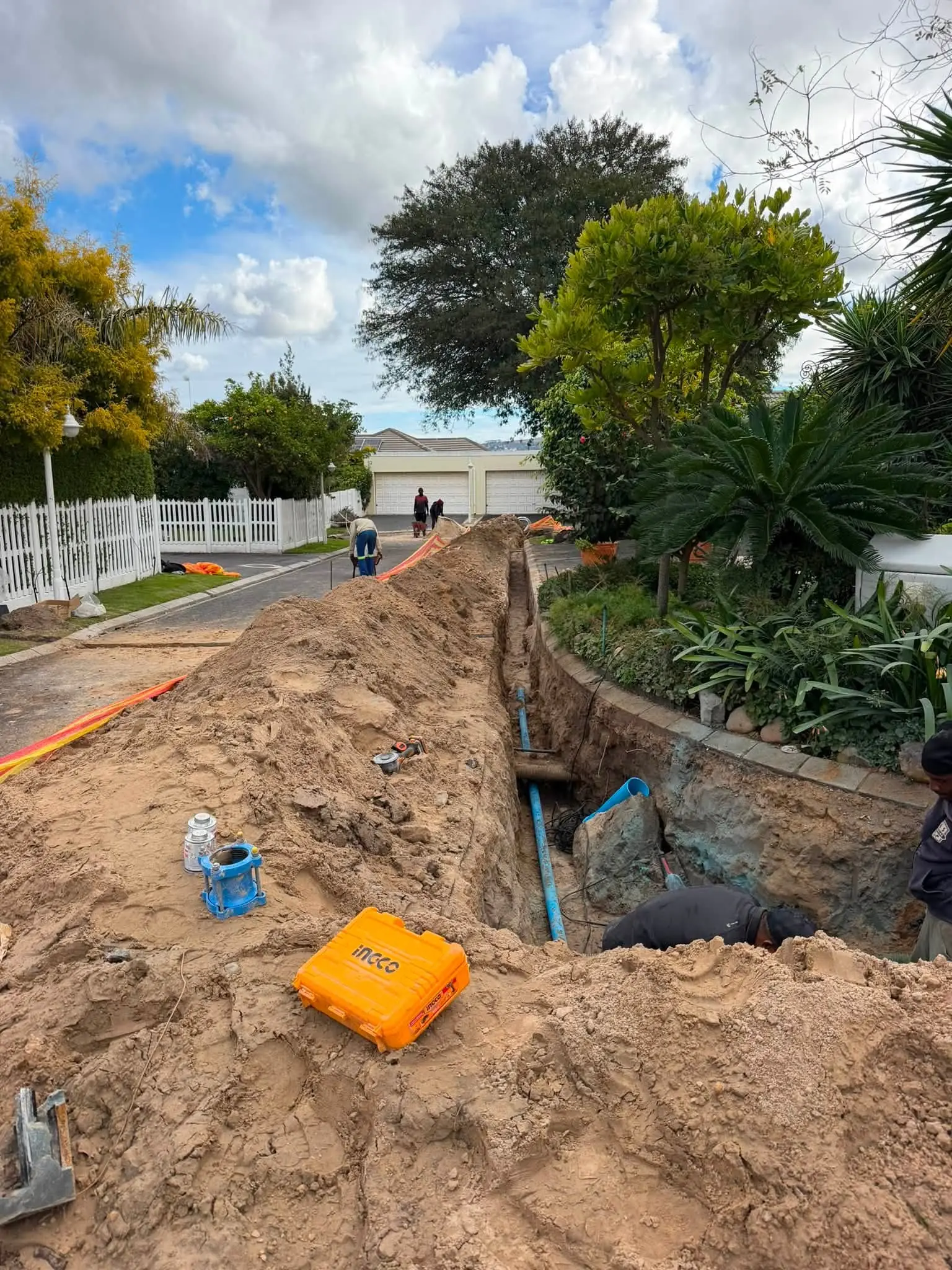 Excavating alongside a garden to reach an underground line