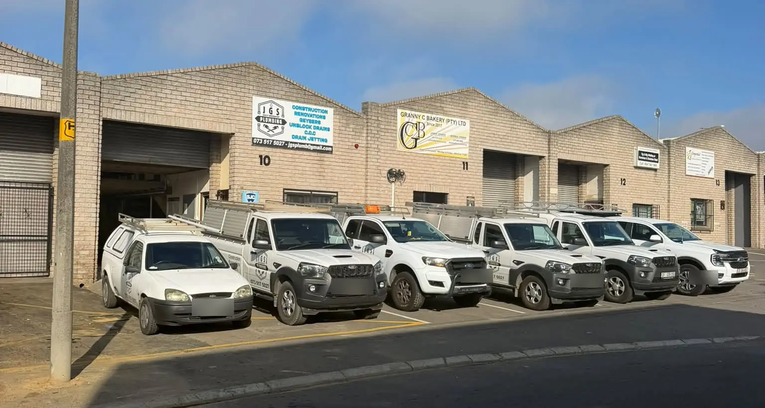 JGS Plumbing's bakkies outside their units at N1 Park, Brackenfell